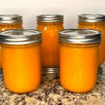 Five Ball mason jars with pumpkin puree ready to be frozen