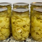 Six Ball mason jars filled with waterbath canned pickled banana peppers