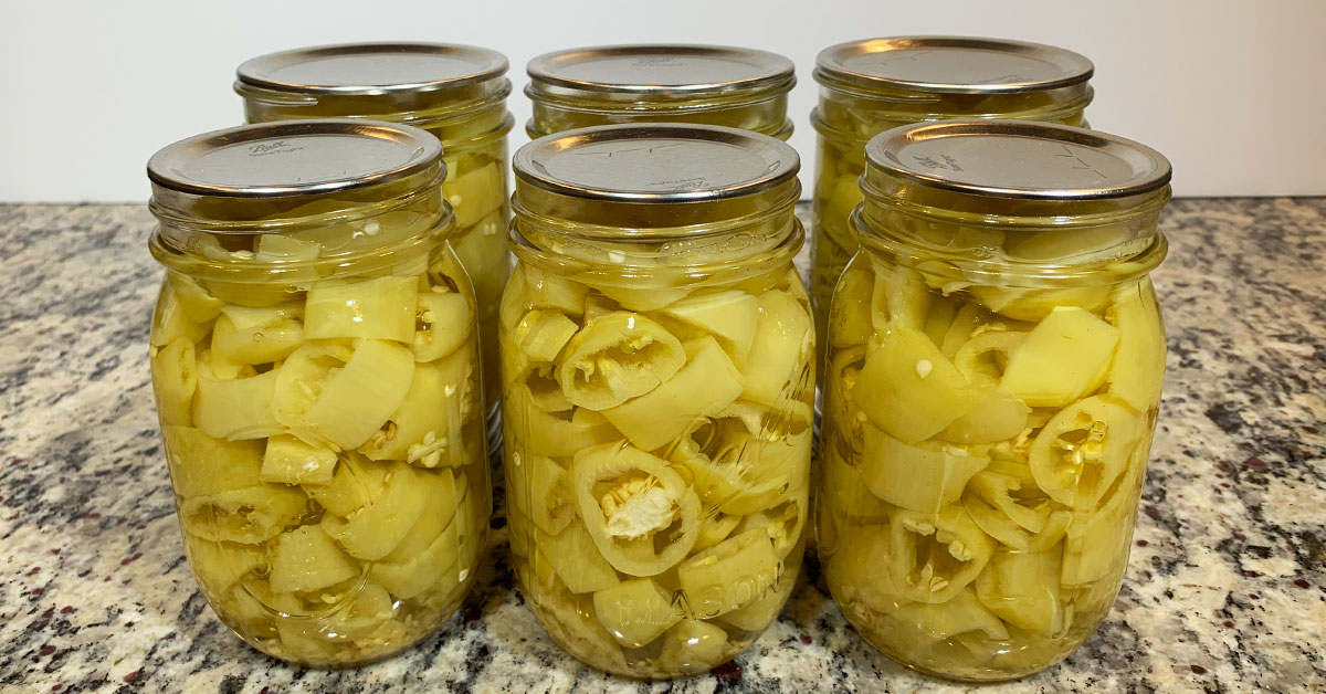 Six Ball mason jars filled with waterbath canned pickled banana peppers