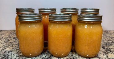 Seven Ball mason jars containing waterbathed applesauce