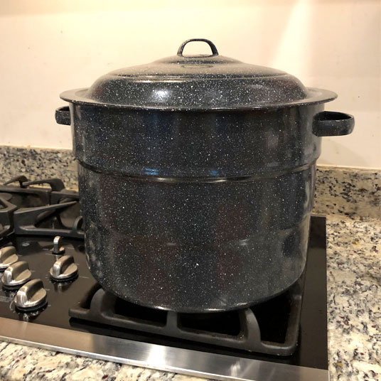 Granite Ware Water Bath Canner Pot sitting on gas stovetop.