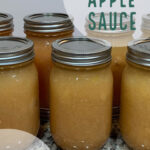 Pint size mason jars full of homemade apple sauce sitting on a counter.