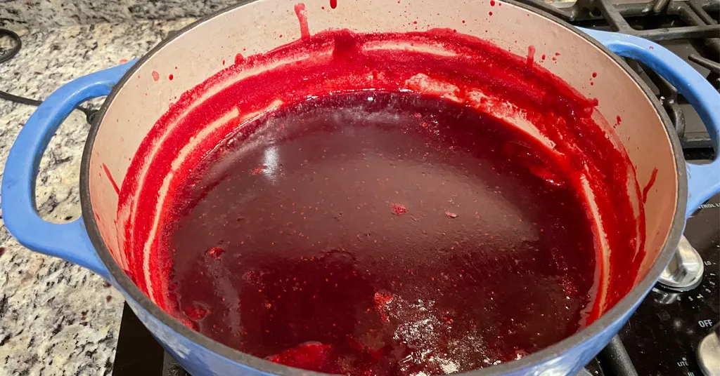 Cranberry Jelly in a blue enameled dutch oven