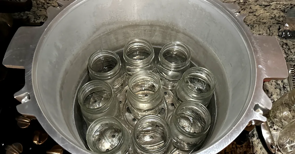 All American Pressure Canner with empty pint sized mason jars.